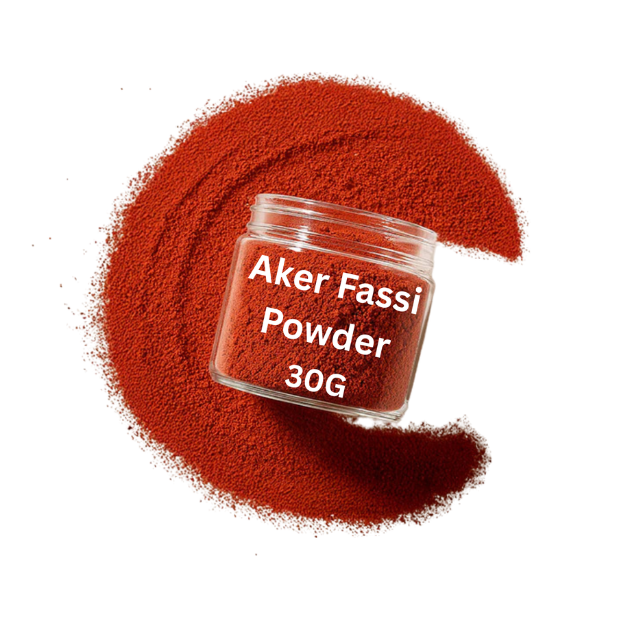 Jar of Aker Fassi Powder with red powder spilled around on a white background