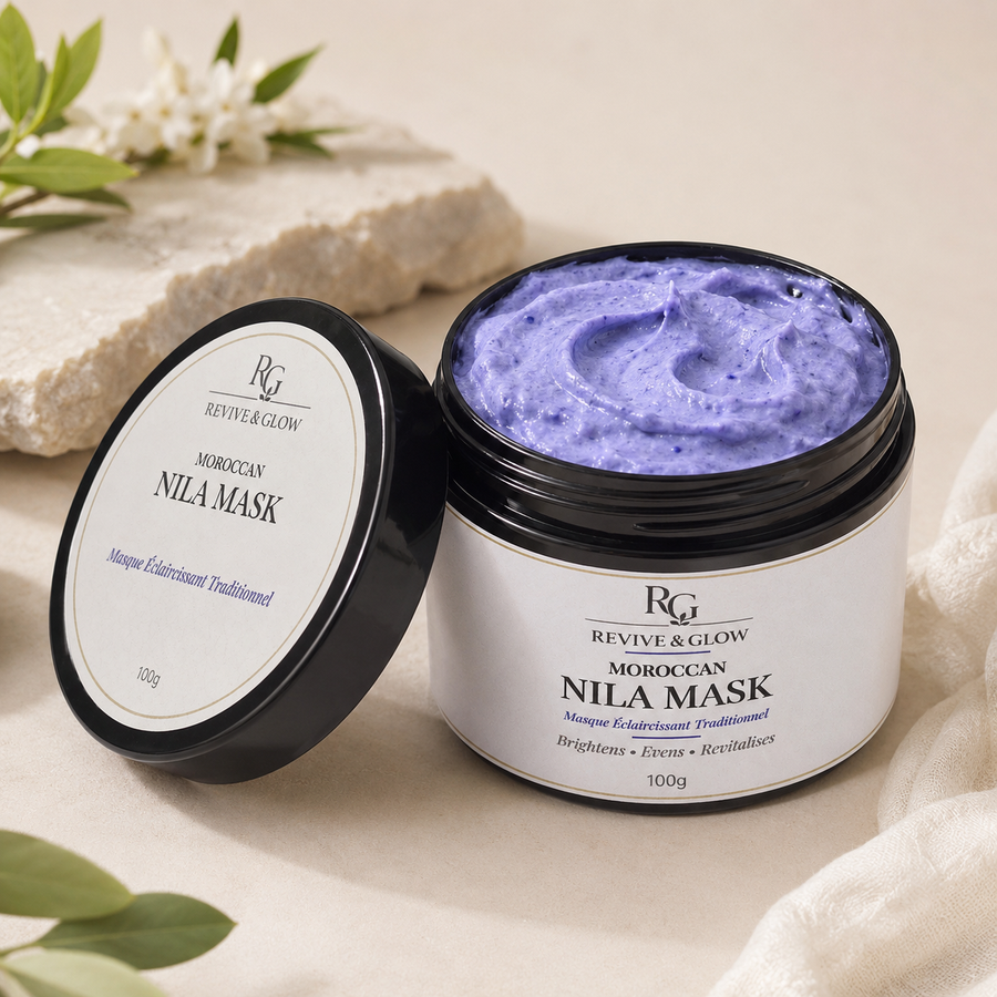 An open black cosmetic jar showing a lavender-purple mask cream inside, with its matching lid leaning beside it. The label reads 'RG Revive & Glow Moroccan Nila Mask.