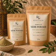 Two stand-up pouches of Revive & Glow Moroccan Sidr Powder, one 50g and one 100g, displayed on a textured beige surface with a bowl of green powder and green leaves in a warm, styled setting.