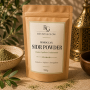 A stand-up kraft paper pouch labeled 'Revive & Glow Moroccan Sidr Powder' stands on a beige surface with decorative props, including a small bowl of green powder, leaves, and a brass lantern in the background.