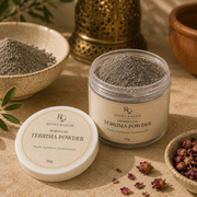 A jar of Moroccan Tebrima Powder and its lid are displayed on a textured beige surface with traditional styling props including a brass lantern, dried rosebuds, and another bowl of powder.