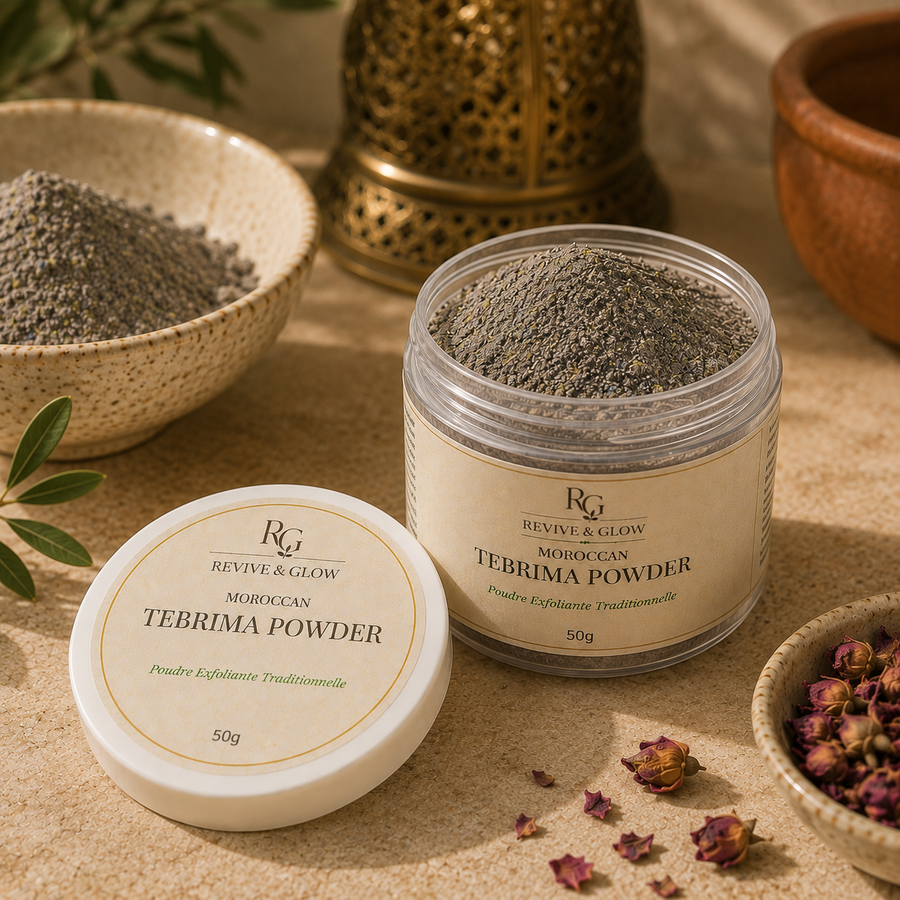 A jar of Moroccan Tebrima Powder and its lid are displayed on a textured beige surface with traditional styling props including a brass lantern, dried rosebuds, and another bowl of powder.