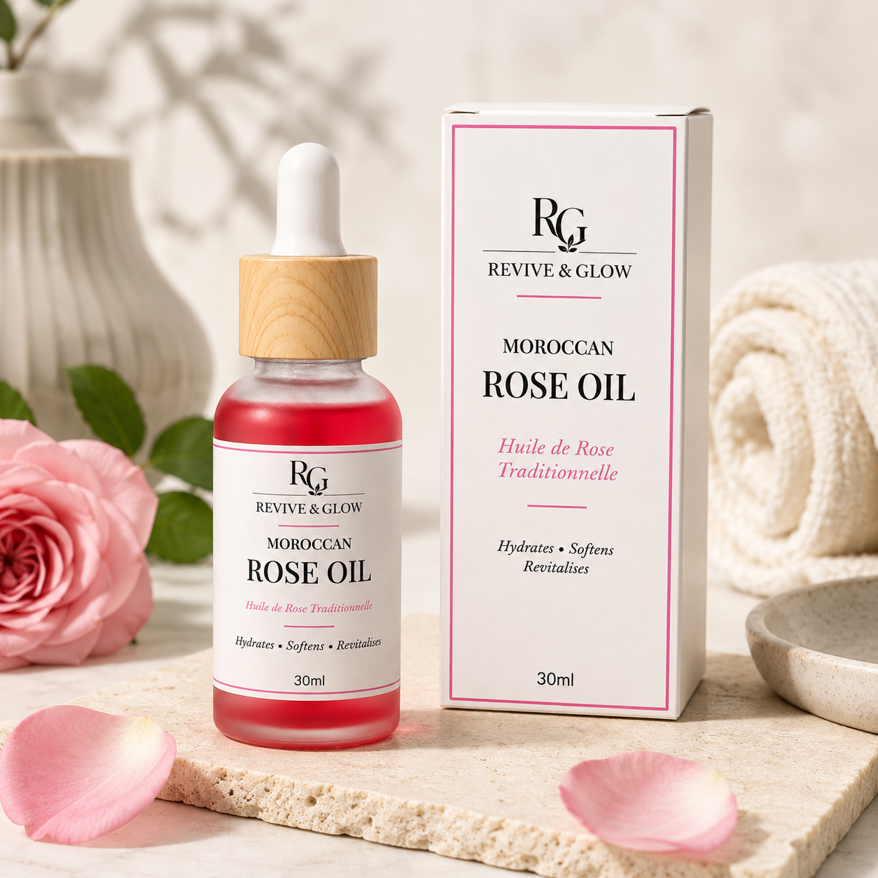 Revive & Glow Moroccan Rose Oil 30ml displayed in a luxury spa setting with fresh pink roses and premium packaging.